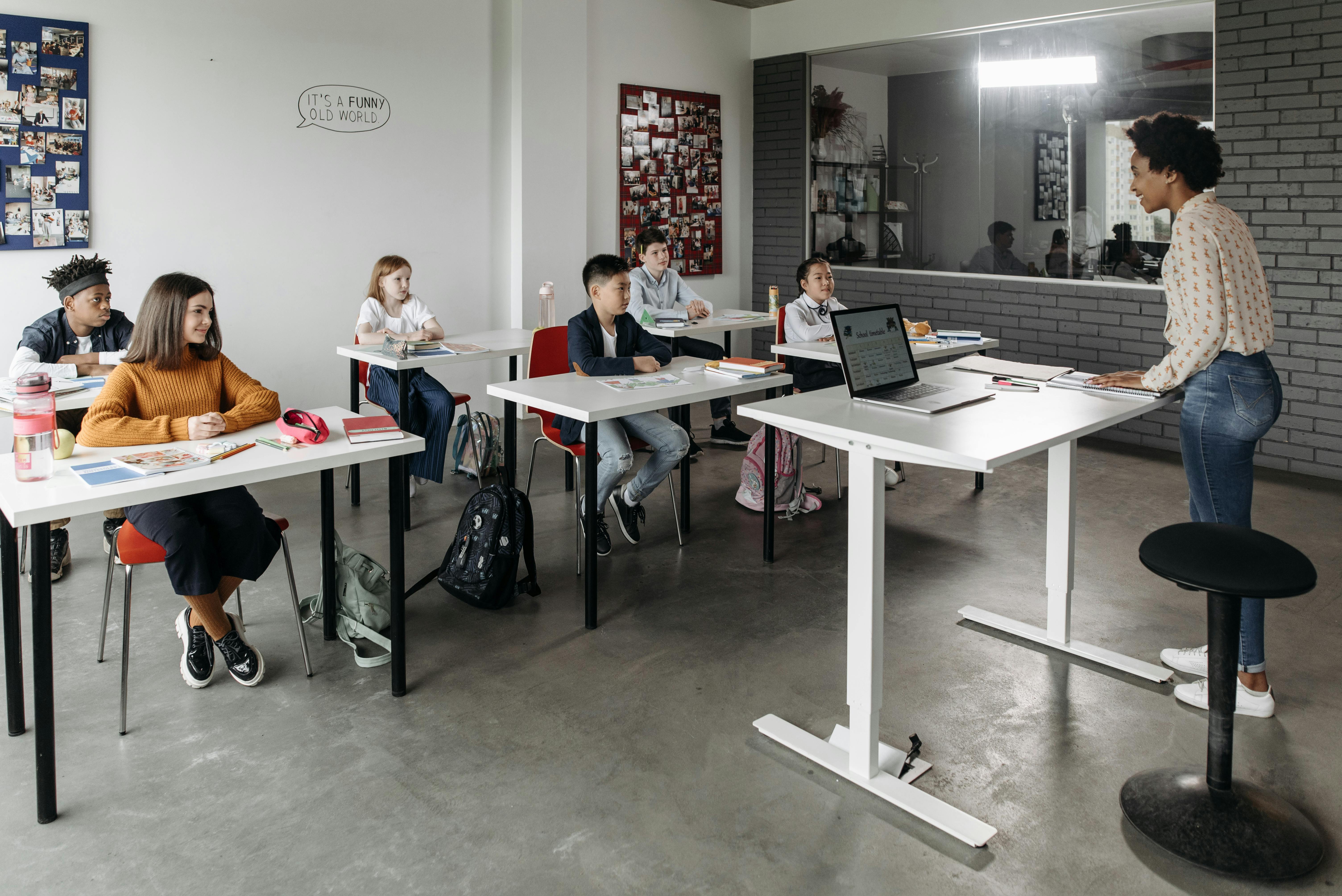Teacher helping students learn in a classroom